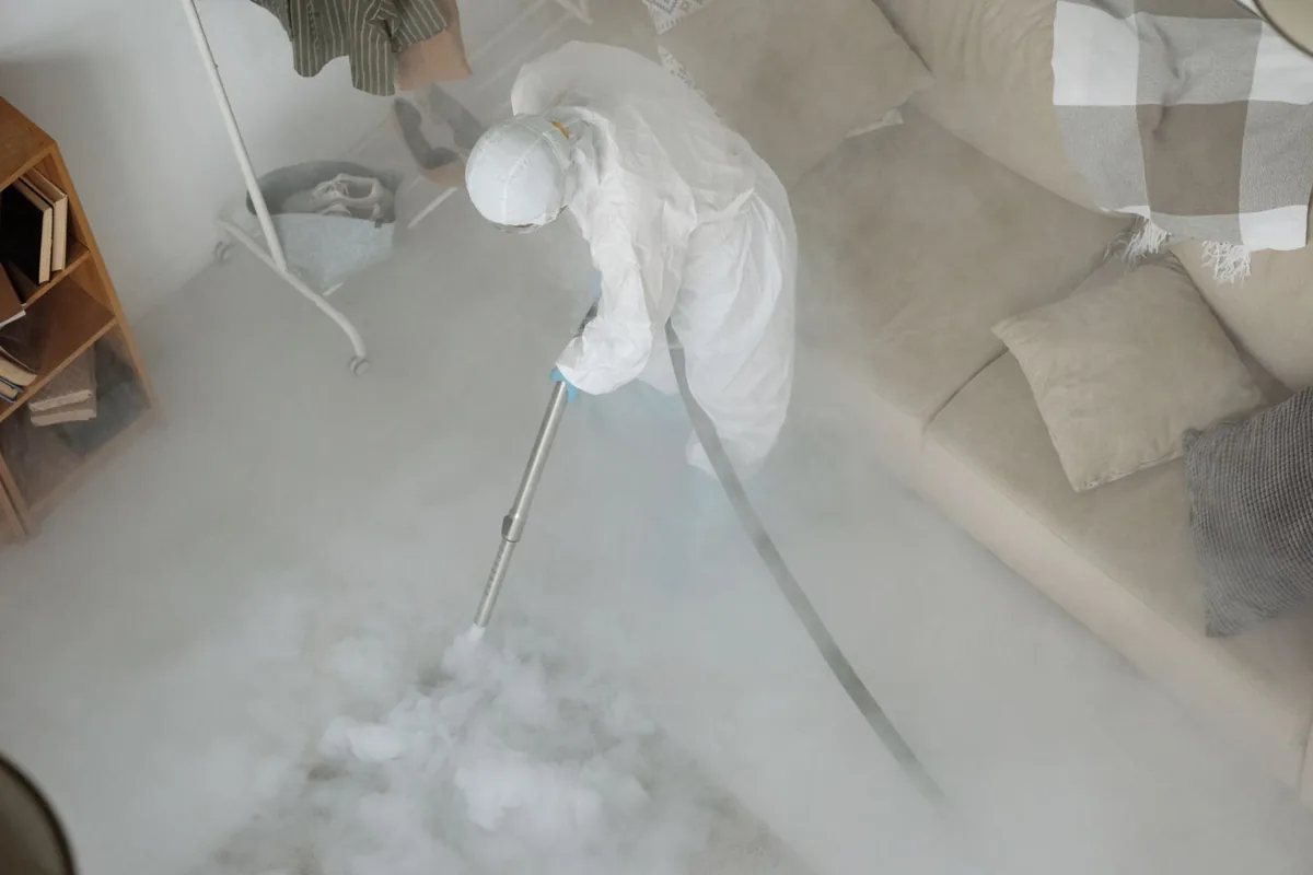Biohazard cleanup technician in protective equipment, Roswell, NM